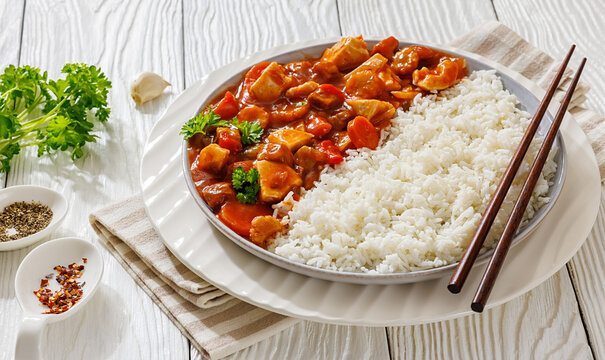 Sweet and sour chicken with rice on plate