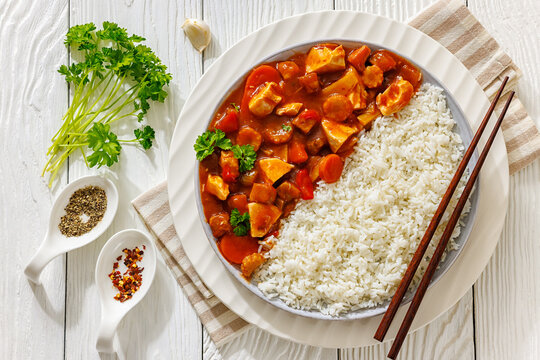 Sweet and sour chicken with rice on plate
