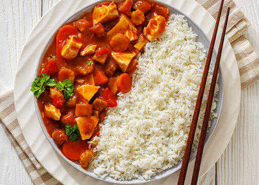Saucy chicken with carrots, baby corn, and rice
