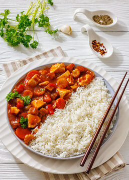 Saucy chicken with carrots, baby corn, and rice