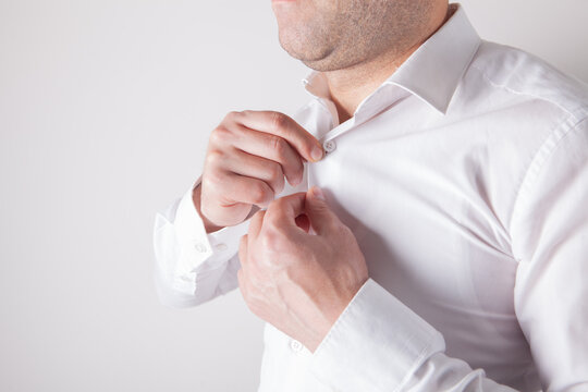 Man in a white shirt with a bandage on his wrist.