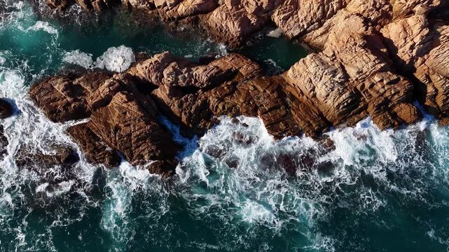 Waves crashing on rocky coast seen from above Costa Brava Spain