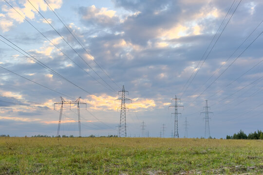 Power lines stretch across a grassy field