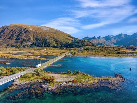 Scenic Lofoten landscape along the E10 at Gims&oslash;ystraumen Bridge with turquoise water and mountains