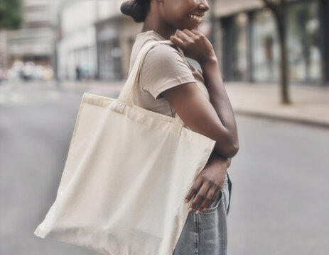 Blank white tote bag mockup carried on a city street