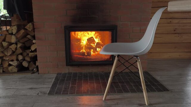 Modern living meets traditional warmth: fireplace in minimalist interior during the energy crisis. stove that keeps home warm winter. Savings electricity, fuel other resources. crisis heating sector