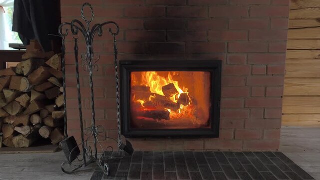 Fireplace in rustic setting practical solution for heating amid energy price hikes. stove that keeps home warm in winter. Savings on electricity, fuel and other resources. A crisis in heating sector.