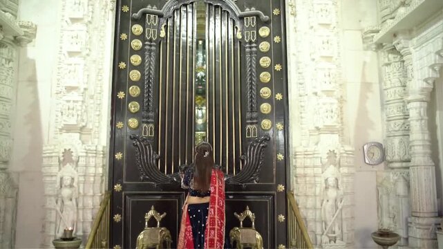 Opening the Ornate Inner Door of a Jain Temple to Reveal Sacred Idols of Shri Parshvanath Bhagwan and Other Jain Tirthankars During Religious Worship