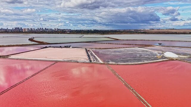 Salt extraction takes place in broad evaporation ponds, where water and salt collect in separate basins near the coast during daytime.