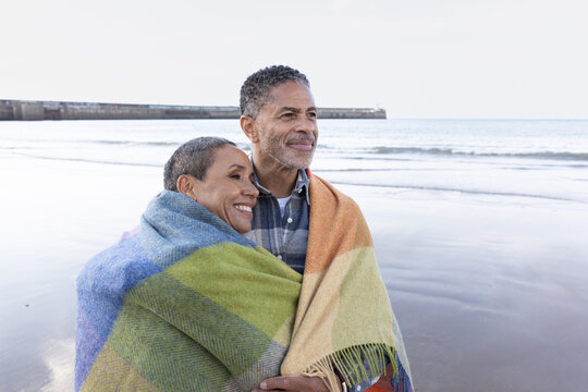 Senior Couple Embracing the Ocean Breeze on the Beach