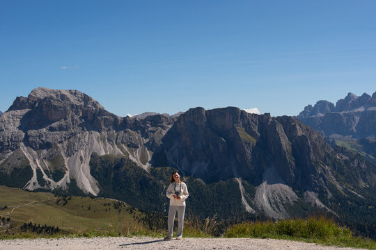 A traveler pauses on a gravel ridge in the Italian Alps