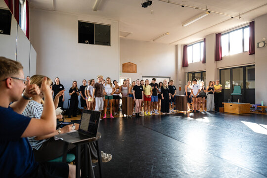 Cast standing for a group review
