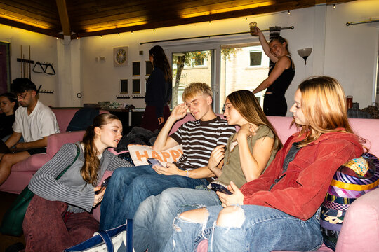 Wide shot of a student dormitory common area with friends