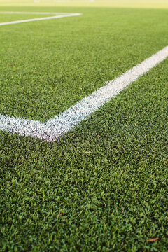Synthetic turf grass sports field abstract green and white background
