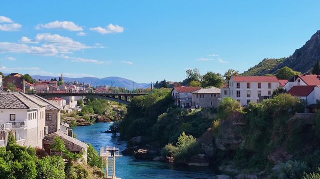 Scenic aerial drone footage of the historic Stari Most Old Bridge spanning the Neretva River in the city of Mostar, Bosnia and Herzegovina