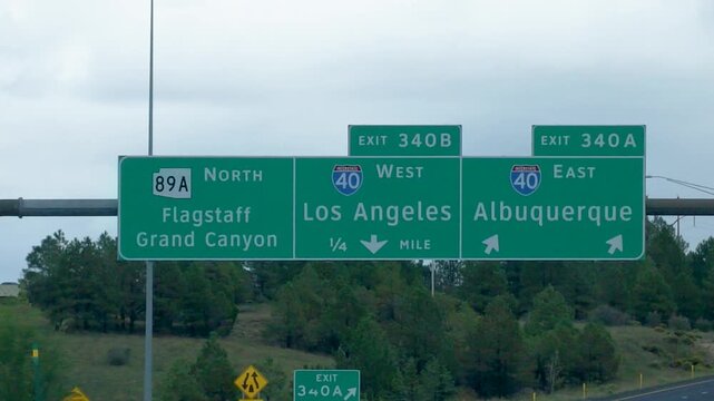 Interstate 40 exit signs toward Flagstaff, Los Angeles and Albuquerque in Arizona