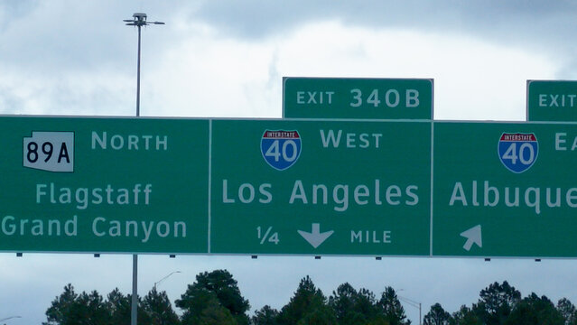 Interstate 40 exit signs toward Flagstaff, Los Angeles and Albuquerque in Arizona
