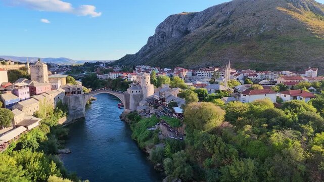 Scenic aerial drone footage of the historic Stari Most Old Bridge spanning the Neretva River in the city of Mostar, Bosnia and Herzegovina