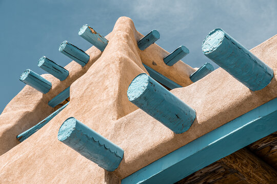 Looking up at an impressively large Adobe structure in Taos, New Mexico