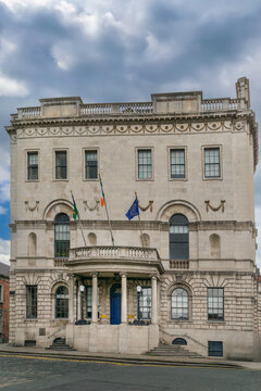 Rates Office Newcomen Bank building in Dublin Ireland. Historic facade with flags and classical architecture balcony