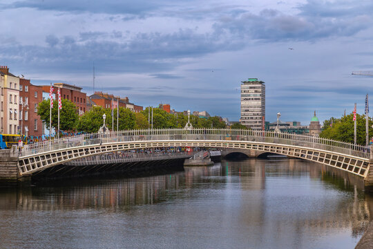 Scenic view of Liffey river with Ha'penny Bridge in Dublin Ireland. Historic cast iron arch architecture landscape