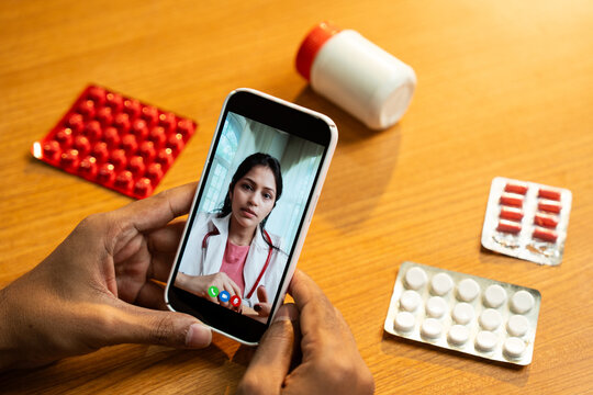Female Doctor Providing Telemedicine Consultation via Smartphone Video Call