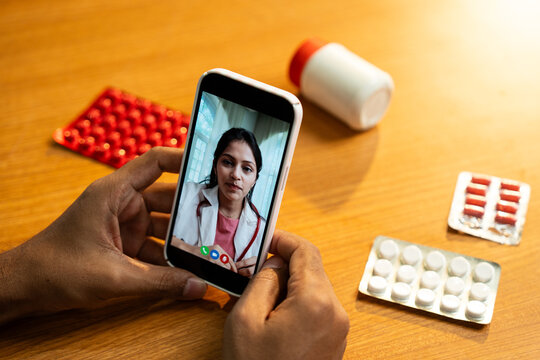 Female Doctor Providing Telemedicine Consultation via Smartphone Video Call