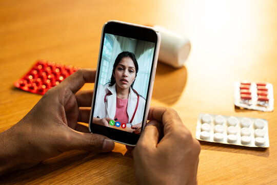 Female Doctor Providing Telemedicine Consultation via Smartphone Video Call