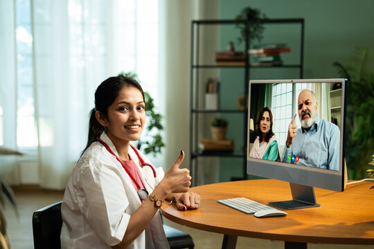 Young Indian Female Doctor Providing Online Consultation from Cozy Clinic