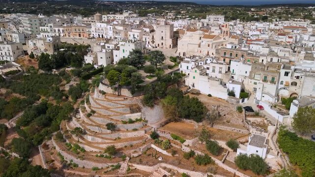 Cisternino Puglia Italy most beautiful village aerial view of stepped terraces. High angle over white houses, traditional Mediterranean architecture and Valle d Itria olive groves
