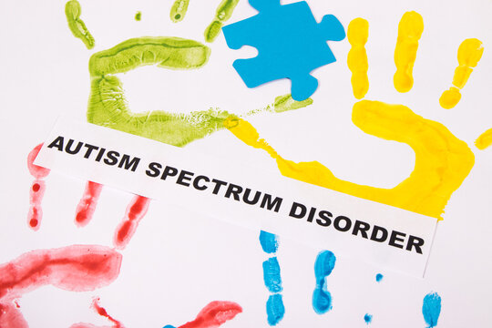 Kids handprint made of paint and inscription Autism Spectrum Disorder. World Autism Awareness Day