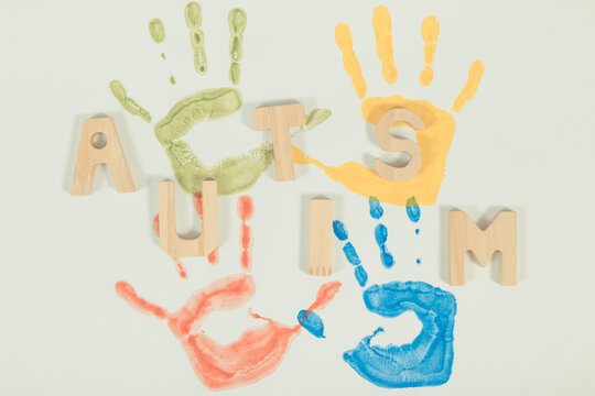 Kids handprint made of paint on white background. Autism spectrum disorder. Autism awareness