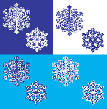 Beautiful pattern of stylized, symmetrical snowflakes against dark blue, white, and light blue backgrounds. Winter and Christmas atmosphere. Christmas-themed print in shades of blue.