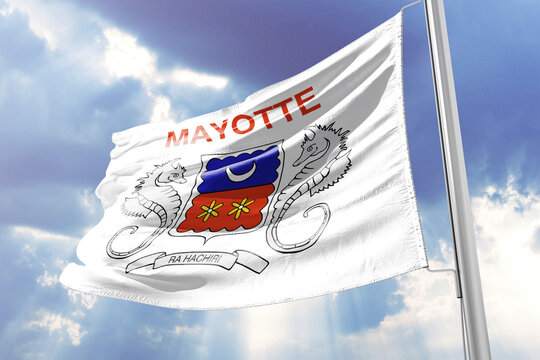 Flag of Mayotte waving against a blue sky with clouds