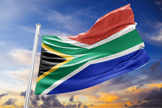 Waving Flag of South Africa against a Cloudy Sky at Sunset