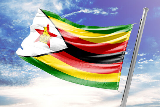 Flag of Zimbabwe Waving against a Cloudy Blue Sky
