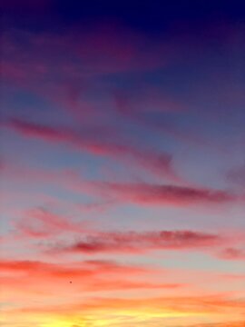  Colorful vertical twilight sky with glowing horizon gradient and soft clouds