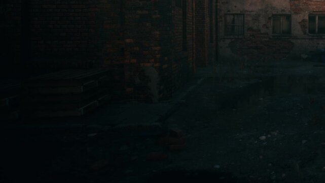 The scene shows a dark alley filled with bricks and debris. The ground is uneven and the walls appear worn, with broken windows in the background, typical of an old urban area at night.