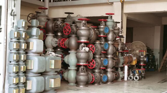 Stacked industrial pipe valves, flanges, and marine plumbing hardware