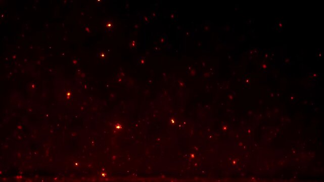 Red embers falling like cinders through near-black