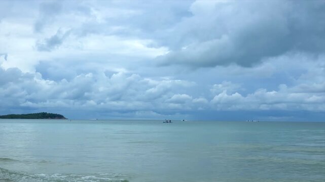 Blue ocean under heavily overcast dramatic sky with dark storm clouds