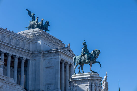 Vittoriano monument with equestrian statue of Victor Emmanuel II and quadriga against blue sky, Rome, Italy