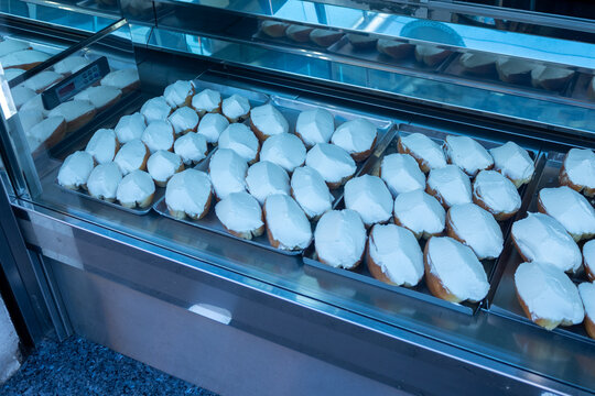 Maritozzi with whipped cream in a pastry shop display case in Rome, Italy