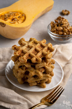 Sweet baked pumpkin waffles on a plate on the table
