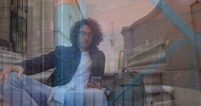 Sitting man wearing denim jacket using smartphone on stone steps, backpack beside, chart overlay