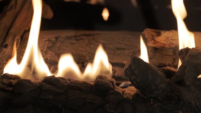 Close up of burning bioethanol fireplace with flames dancing around artificial wooden logs