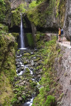 Hiker at Levada do Moinho, Waterfall in a gorge, Ponta do Sol, Madeira, Portugal