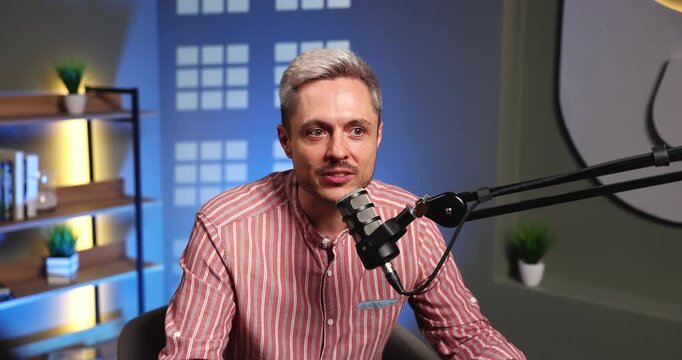 Male podcast host or guest speaking into mic for content recording sharing personal experience engaging audience with emotional commentary and narrative storytelling during professional studio session