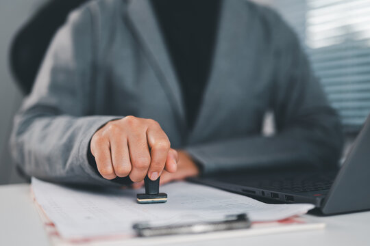 Business contract document stamping with approval seal, agreement verification, official paperwork process, legal compliance and corporate documentation concept.