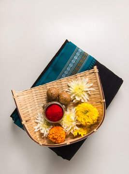 A makar sankranti elements like Tilgul, kumkum and black saari. A Sankranti festive objects and ingredients.